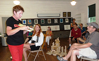 Andrew Phillips (far right), a faculty member at the
Charter High School for Architecture and Design, listens to a
participant in Fallingwater’s summer residency program.